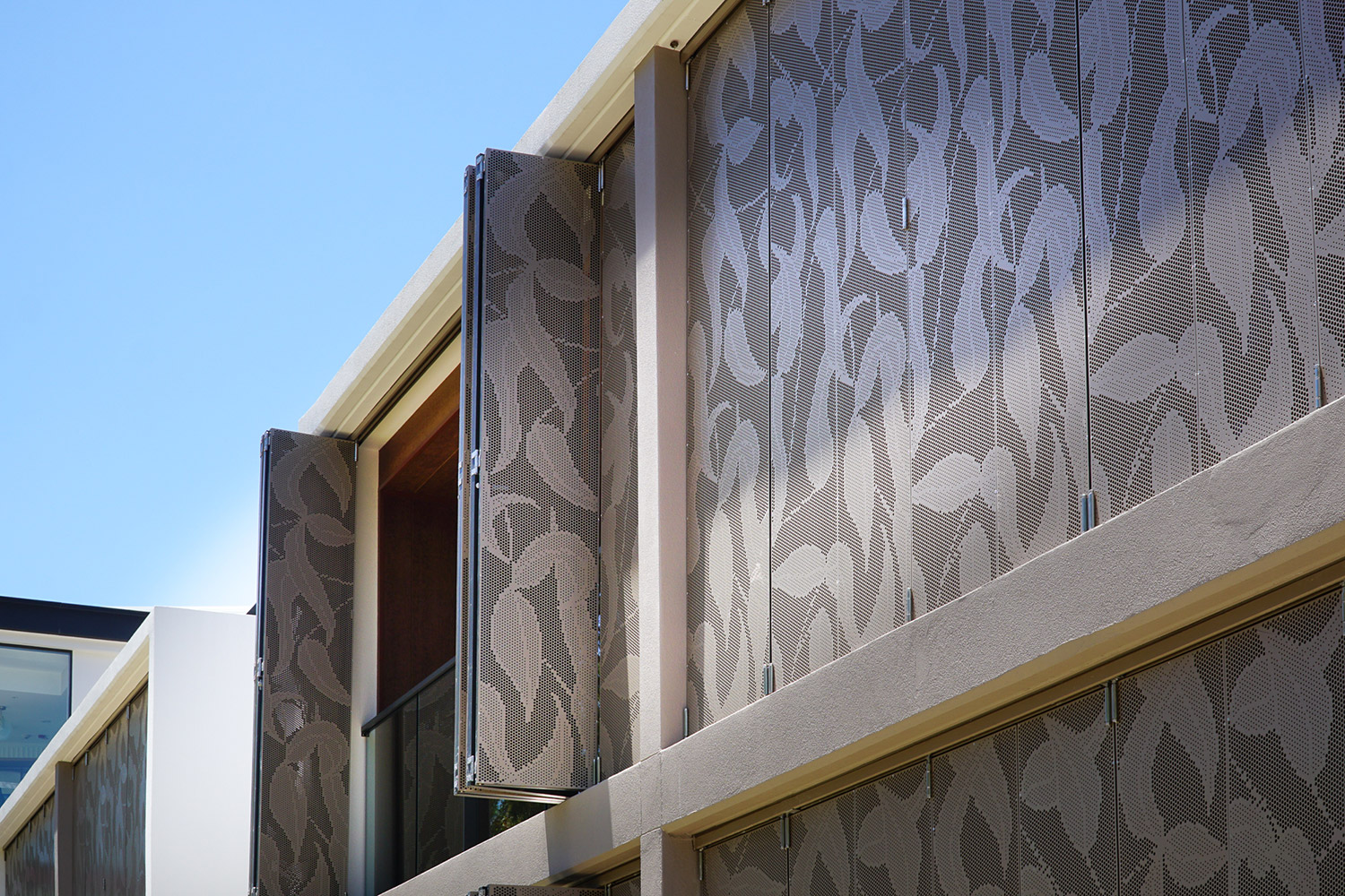 Perforated metal panels with customized pattern to improve acoustic performance at the Carrington Riverview apartments, Camden, Australia